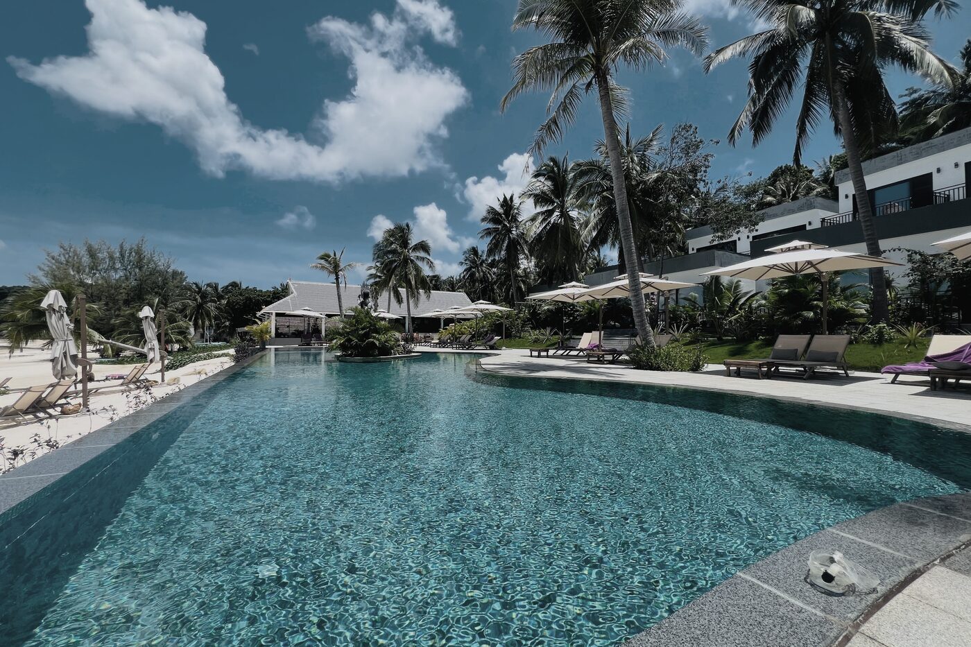 Apsara Resort infinity pool surrounded by palms and suites